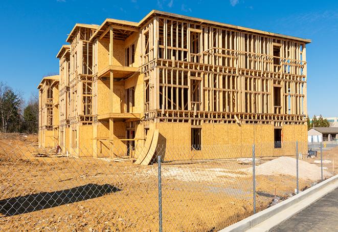 a temporary chain link fence winding around a construction site, outlining the project's progress in Sparks, NV